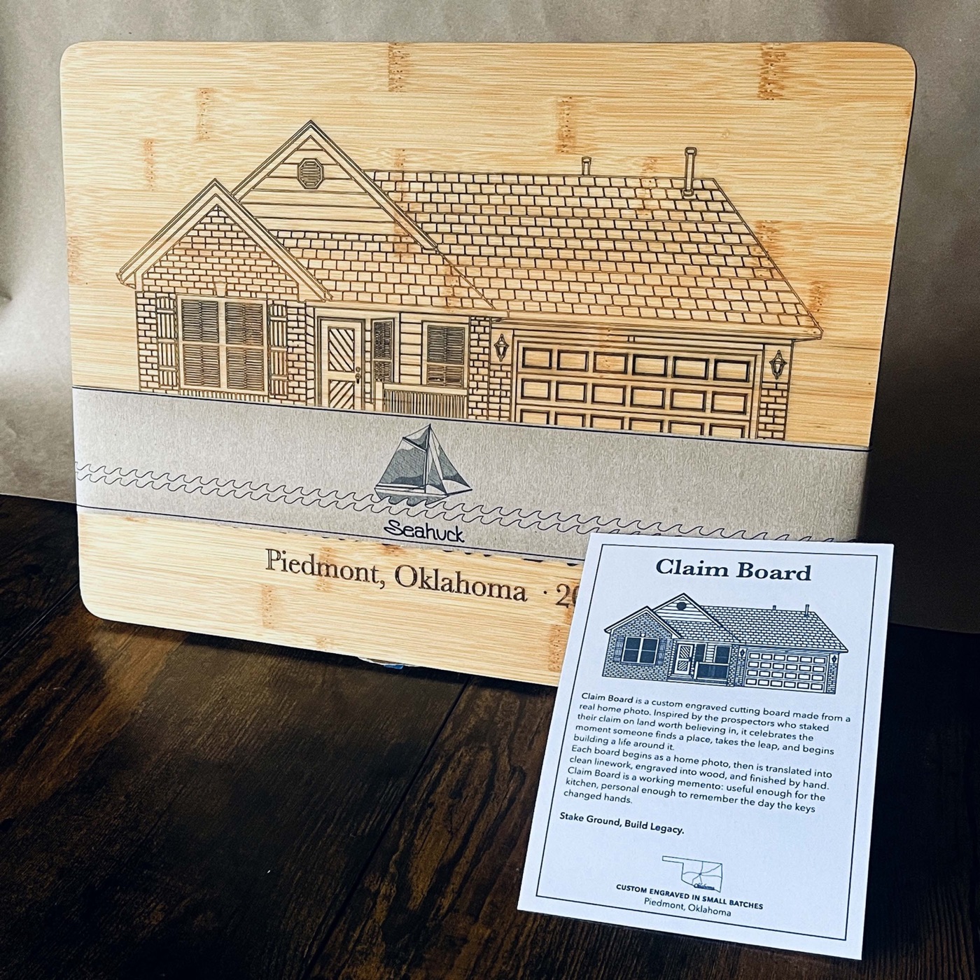 A custom house portrait engraved on a bamboo cutting board with Seahuck packaging